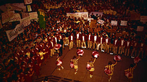 Vintage homecoming photo of cheerleaders and crowd